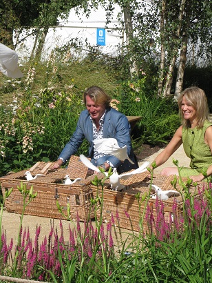 David Domoney and helper releasing doves at The Quiet Mark Tree House, Hampton Court Flower Show 2014