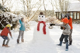 Shutterstock_54060898. Children and snowman